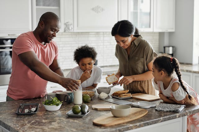 A family making dinner at a counter.