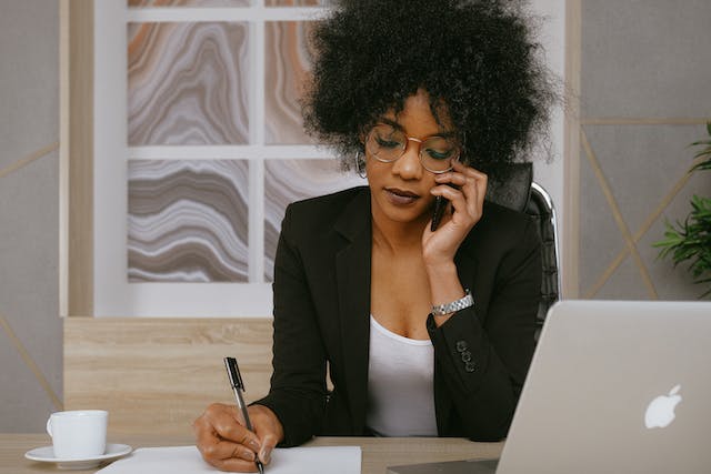 A landlord on a phone call taking notes.