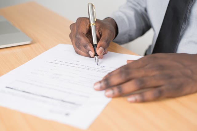 A person signing a contract.